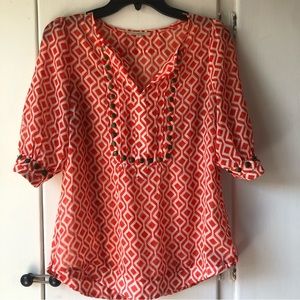 41 Hawthorn sheer orange patterned blouse with brass grommet accents